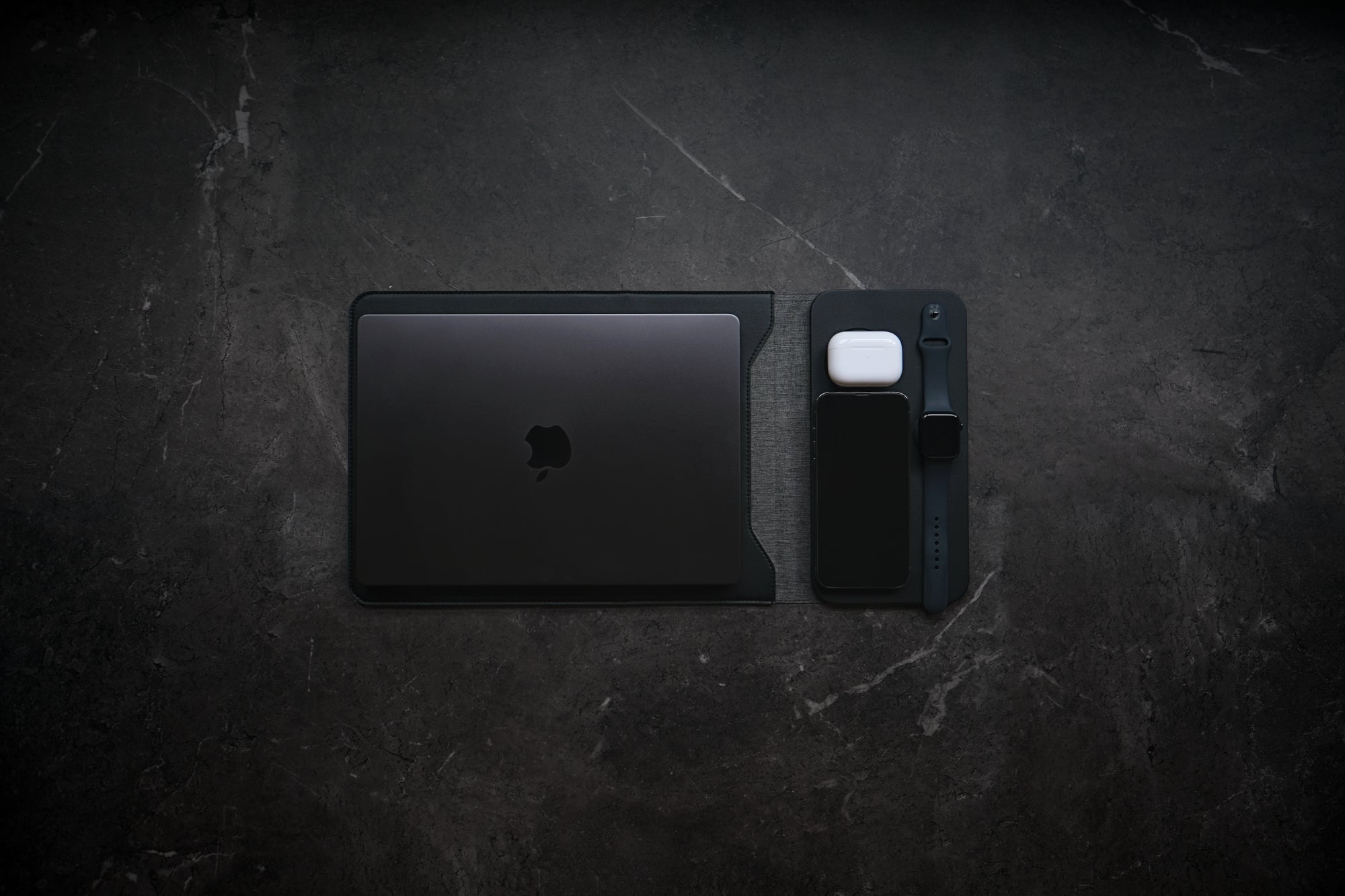 NODE. Minimalist Black Laptop Sleeve with Apple Magsafe compatible charging docks for iPhone, Airpods and Apple Watch.