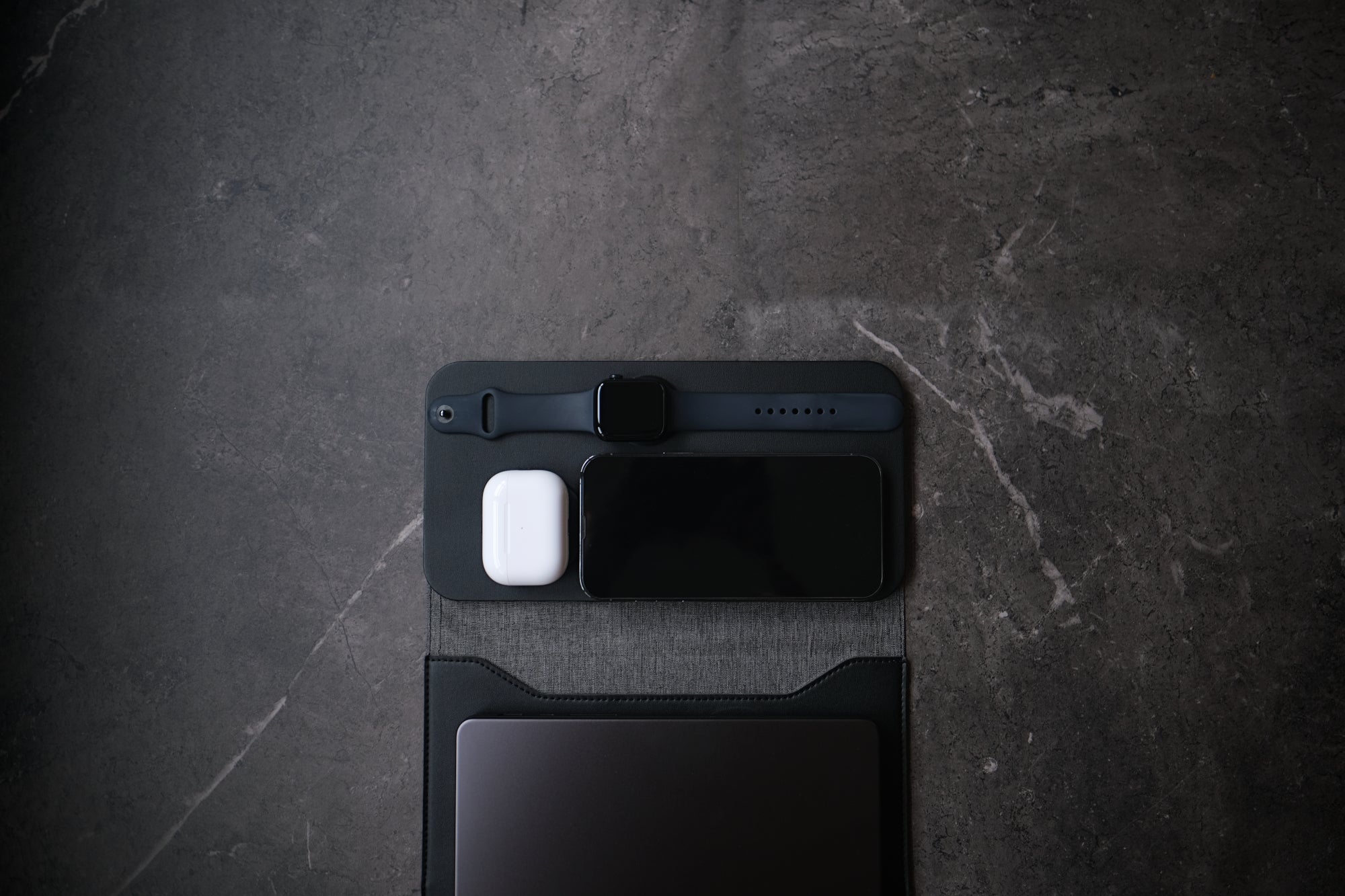 NODE. Minimalist Black Laptop Sleeve with Apple Magsafe compatible charging docks for iPhone, Airpods and Apple Watch.