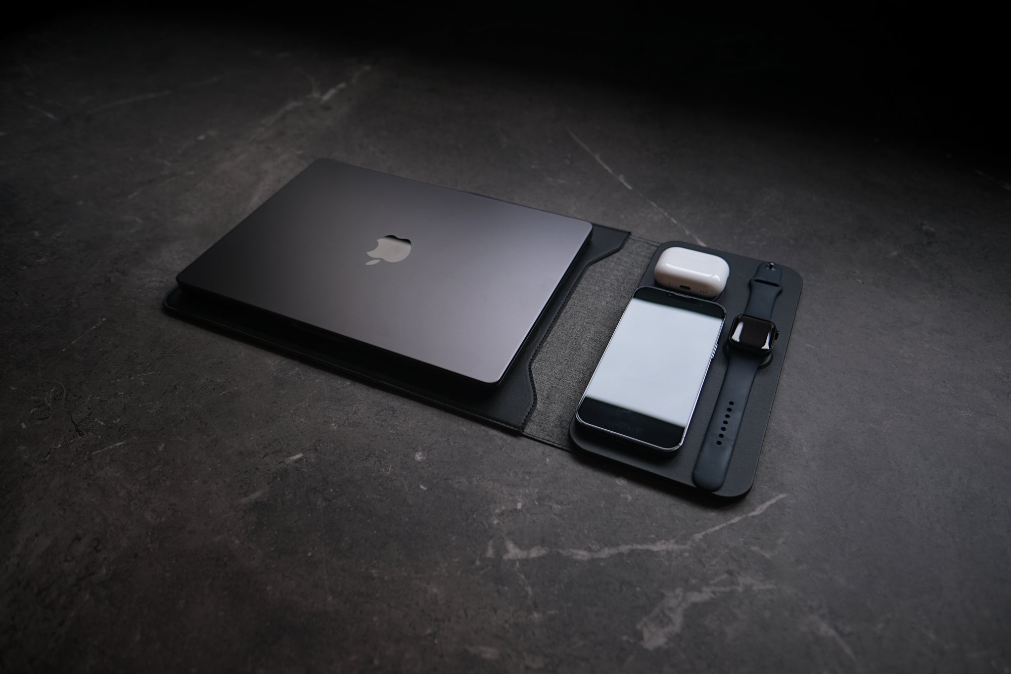 NODE. Minimalist Black Laptop Sleeve with Apple Magsafe compatible charging docks for iPhone, Airpods and Apple Watch.